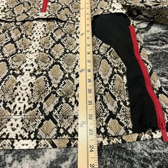 ALALA snakeskin anorak with red accents